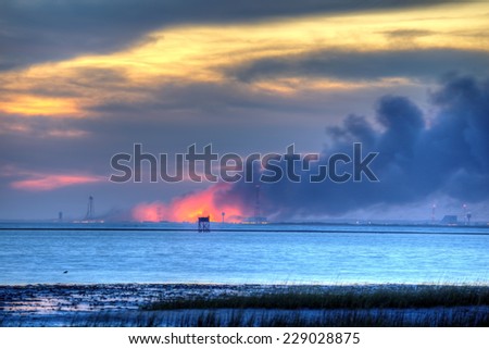 WALLOPS ISLAND, VIRGINIA - OCTOBER 28: An Orbital Sciences Corp. rocket burns on the ground at NASA\'s Wallops Flight Facility on October 28, 2014.  The rocket exploded a few seconds after launch.