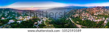 Beatiful panoramic landscape view of a Lebanese village on a mountain side at sunset with a sea view