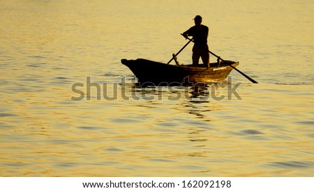 boat with a man on the background of the sea at sunset,Venice, Italy