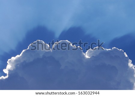 cloud with a halo of sunlight against the blue sky.
