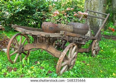 Old wooden cart with pink flowers