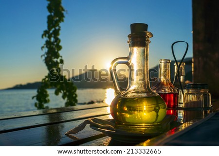 bottle with olive oil on a background of sea sunset