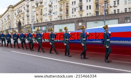 MOSCOW, RUSSIA-AUGUST 7. Guards of the presidential regiment carry a huge tricolor Russian flag on Tverskaya Street September 7, 2014. Procession in honor of the 867 birthday of the city of Moscow