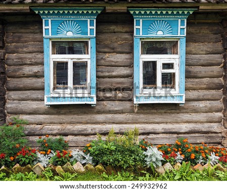 facade of the old wooden houses decorated with flowers