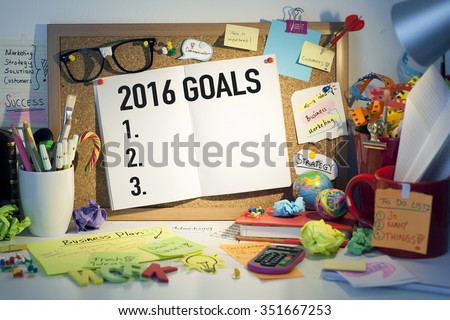 2016 goals plans aspirations and resolutions concept with list on cork bulletin board in office