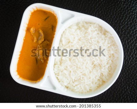 Takeaway rice and curry in a meal box.