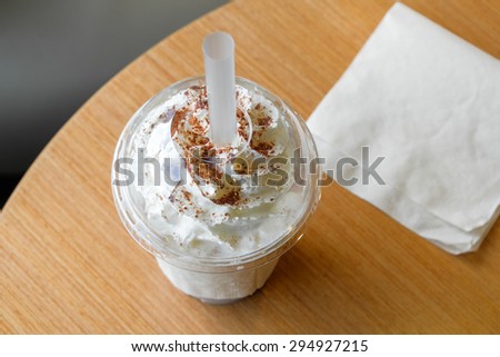 Ice chocolate frappe and whipped cream in the takeaway plastic cup