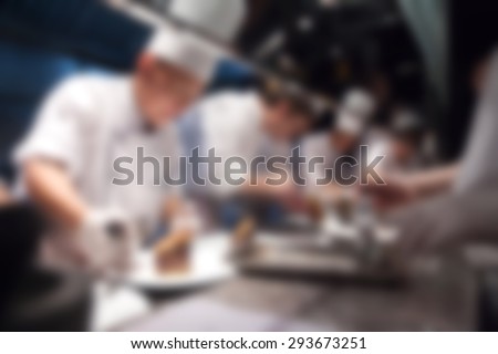 Blurry of Chef in hotel or restaurant kitchen cooking for party