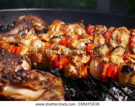 barbecue with  meat on metal grill