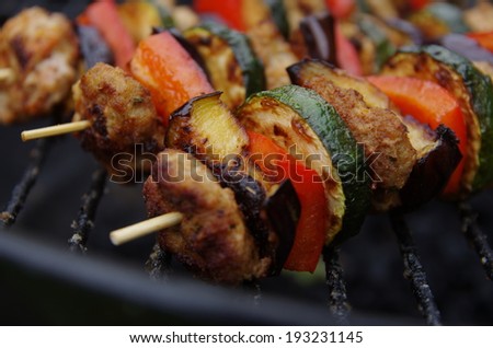 barbecue with  meat on metal grill