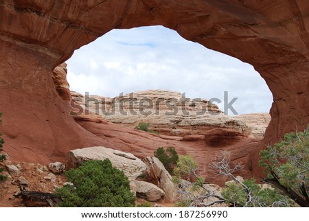 Looking through Broken Arch in Arches National Park, Utah, USA. Broken Arch is one of the more than 2000 natural stone arches located close to Moab.