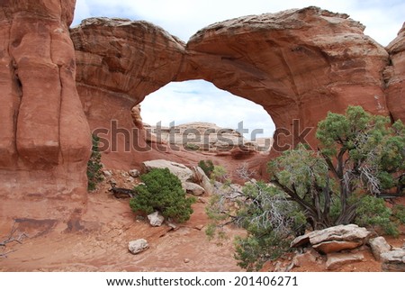 Looking through Broken Arch in Arches National Park, Utah, USA. Broken Arch is one of the more than 2000 natural stone arches located close to Moab.