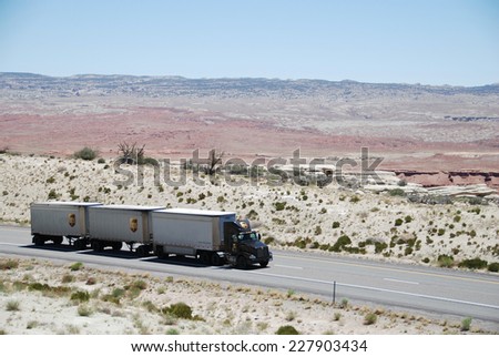 SAN RAFAEL VALLEY, UT, USA - JUNE 6, 2008: a truck drives through San Rafael desert on Route 70. Trucks carry nearly 70 percent of all freight transported annually in the U.S.