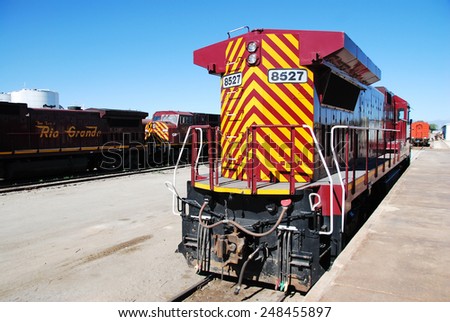 ALAMOSA, CO, USA - JUNE 6, 2013: A diesel-powered GE Dash 8-39B locomotive waits for departure at Alamosa station. This locomotive is dedicated to freight transportation.