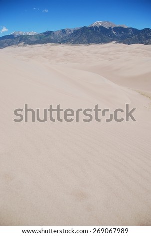 Crestone Peak and Mount Herard seen from Star Dune summit in Great Sand Dunes National Park, CO, USA. Star Dune is the highest dune in North America, rising 750 feet (229 m).