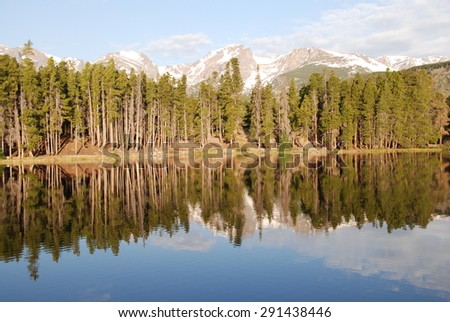 Continental divide reflecting in Sprague lake in the morning light. Sprague lake is one of the beautiful lakes of Rocky Mountain National Park, CO, USA