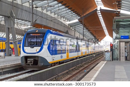 Amsterdam, Netherlands - June 23, 2014: White-blue shuttle train stays on Amsterdam Arena rail station