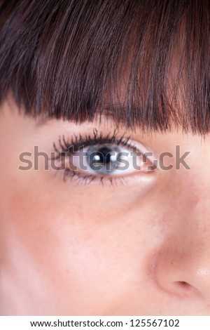 attractive woman eyes closeup part of face (focus on hairs)