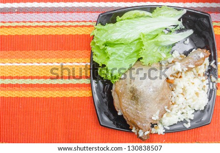 roasted goose leg on linen table cloth
