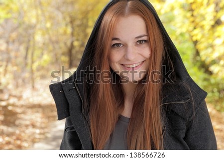 Style redhead girl at beautiful autumn alley face and shoulders shot