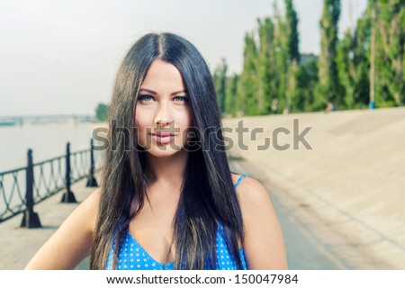 Beautiful young woman enjoy the breeze outdoor in a summer day head and shoulders shot