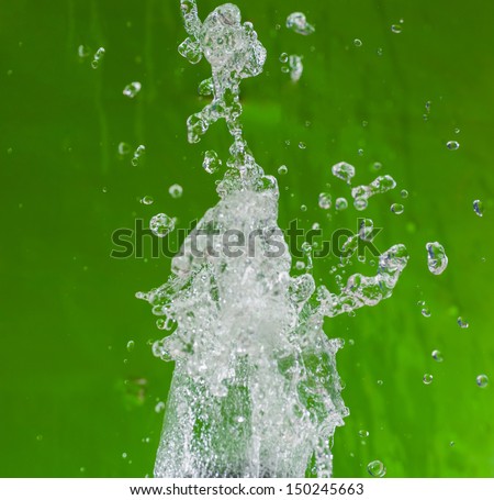 Levitating water drops. Water drops soaring in the air on the gress-green background