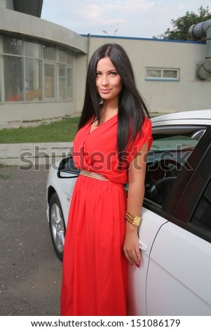 Sexy Beauty Woman In Fluttering Red Dress -near Car