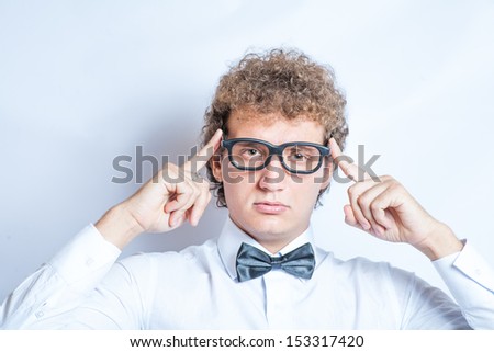 curly man in glasses studio shot on gray background head and shoulders.