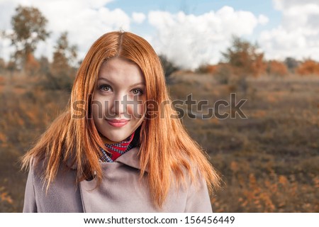 carrot-top women head and shoulders shot smiling and enjoy the autumn