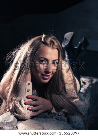 Beautiful blond woman at night looking at camera and smiling.Vertical image