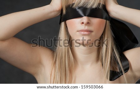 Mysterious beautiful face with ribbon blindfold on eyes