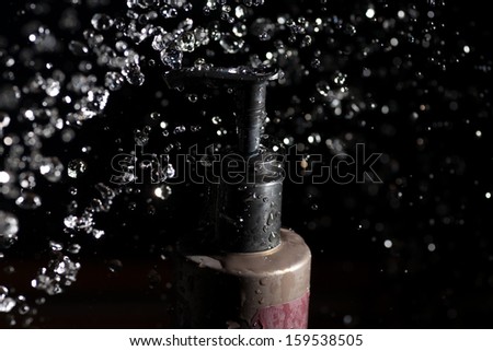 spa  tubes and water drops levitating in the air on the dark background