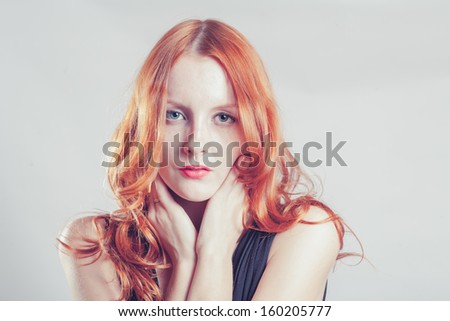 Toned image of the Beautiful sexy woman with red hair (ginger haired or carrot top) with a lot of copyspace