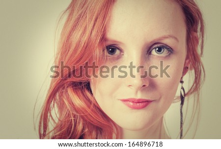 Toned image of the Beautiful sexy woman with red hair (ginger haired or carrot top)
