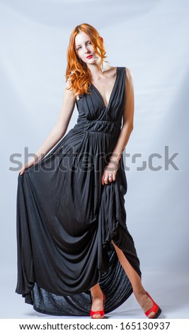 ginger haired slim women full body shot in studio weared black dress