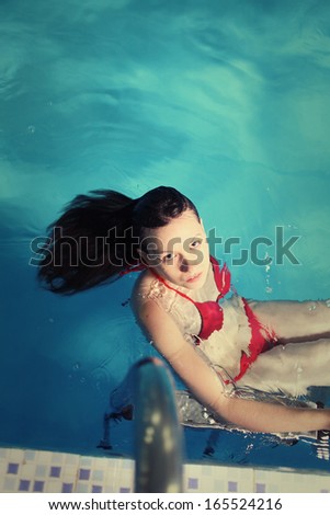 Young Red Bikini Female In Swimming in Pool