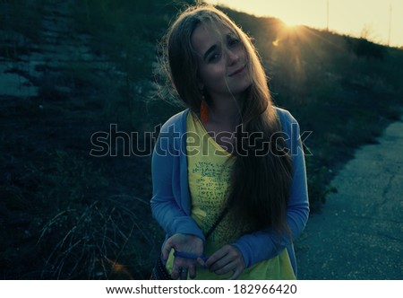Sunset image of a cute blonde. Backlit colorized image