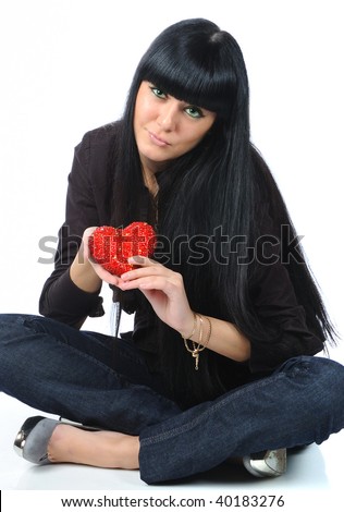 pretty black hair girl in black clothes with red heart in hands isolated on white with reflection