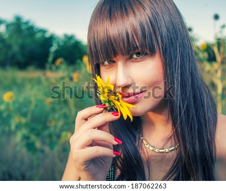 Health and beauty from mother Nature. Women smelling sunflower