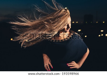 Women with long blond hair in a wind