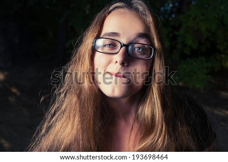Young blond haired women in glasses  in the evening