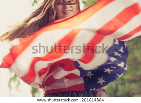Women dancing with US flag blurred motion shot toned image