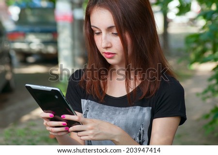 Young woman using app on a talet PC or smart phone. Female student with tablet modile education
