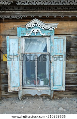 Hut (shantie) window front view. Vintage window of a aged  wooden house in Russia