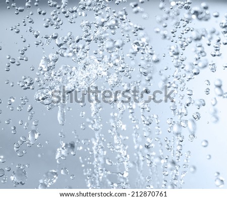 Splashed water drops. Fresh, blue, transparent water. Natural background.