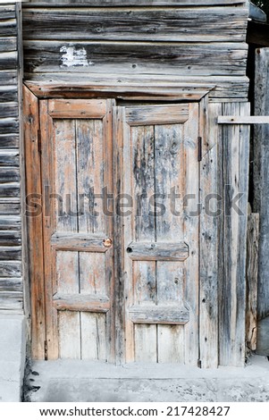 Ancient wooden door closed.  Wooden door of old barn.
