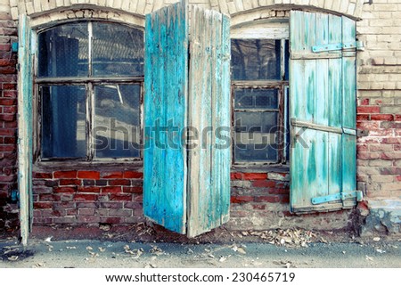 Two open shutter windows of the very old stone building in the historical center of the Astrakhan, Russia