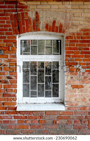 Old red brick house window painted in white color, Astrakhan, Russia