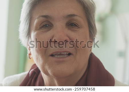 Senior women face smiling closeup toned image.