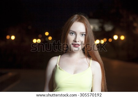 Street fashion. Casual weared women posing in night city on blurred lights background. Street fashion concept - stylish cool girl posing against a defocused colorful urban view. Copy space.